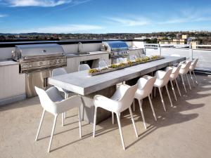 a table and chairs on a patio with a grill at Austin Resort Studio Apartment in Austin