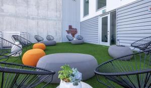 a group of chairs and tables on a patio at Austin Resort Studio Apartment in Austin