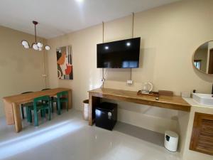 a room with a desk and a table with a television at Koh Tao Stay in Ko Tao +23 photos
