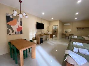 a bedroom with a bed and a table and a desk at Koh Tao Stay in Ko Tao