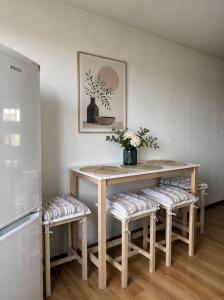 a kitchen with a table and two stools with a table at Cozy Butukas in Kėdainiai