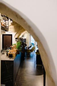 an archway in a restaurant with tables and chairs at Nicanto Rooms in Taranto