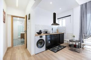 a kitchen with a washer and dryer in a room at Topfix Luxury Home 1 in Kos
