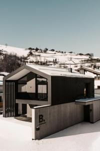 a house on top of a snow covered slope at B Kaprun in Kaprun