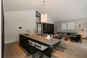 a kitchen and living room with a table and chairs at B Kaprun in Kaprun
