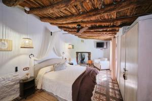 a bedroom with a large bed and a wooden ceiling at Casa Mathilda in Fornes +37 photos