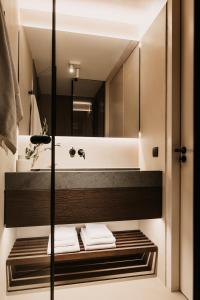 a bathroom with a sink and a mirror at B Kaprun in Kaprun