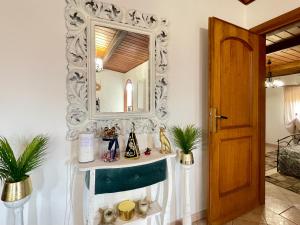 a mirror on a wall in a room with a sink at VILLA PRAXEDES con piscina a Nettuno in Nettuno