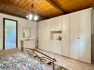 a bedroom with white cabinets and a bed in it at VILLA PRAXEDES con piscina a Nettuno in Nettuno