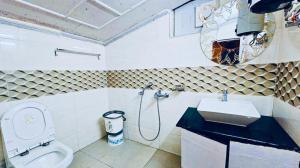 a bathroom with a sink and a toilet at Nainital Hill View Boho in Nainital