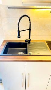 a kitchen sink with a black faucet at Stonehouse-Pag in Povljana +22 photos