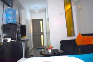 a living room with a couch and a table at Elegant studio apartment in Kiambu Road Tsavo Apartments in Kiambu