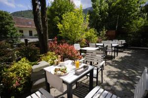 a row of tables and chairs with a plate of food at Barrique 17 - Breakfast at Restaurant & Minibar - Old Town in Braşov