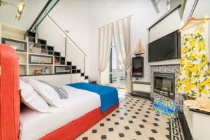 a bedroom with a bed and a fireplace at Amalfi Gallery Room & Suite in Amalfi