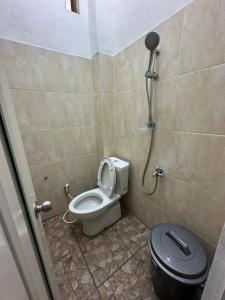 a bathroom with a toilet and a shower at waterspring home in Banyuwangi
