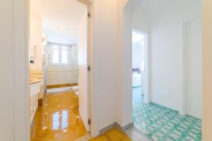 a bathroom with a toilet and a hallway at Amalfi Gallery Room & Suite in Amalfi +44 photos