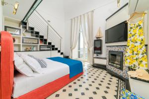 a bedroom with a bed and a fireplace at Amalfi Gallery Room & Suite in Amalfi