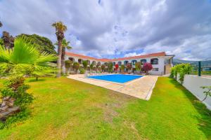 an exterior view of a house with a swimming pool at BURÇ HOTEL in Dalaman