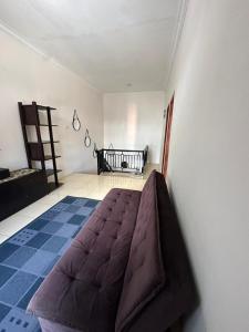 a bedroom with a bed in the corner of a room at waterspring home in Banyuwangi