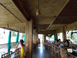 a group of people sitting at tables in a restaurant at Boroli in Shaugaon