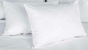 a stack of white pillows on a bed at Alma Motel in Alma