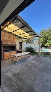 a pavilion with a picnic table and a bench at Hospedaje Buena Vibra in San Nicolás de los Arroyos +22 photos