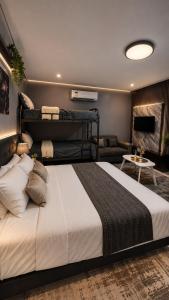 a bedroom with a large bed and a living room at Balai Magayon Hometel in Aplaya