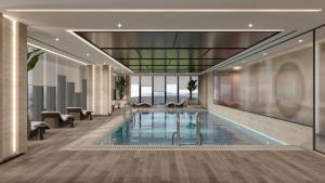 a swimming pool in a building with a lobby at Radisson Blu Residences, Istanbul Kartal in Istanbul