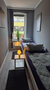 a room with two beds and a window at Stadtnah an der Förde 65 1 in Flensburg