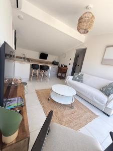 a living room with a couch and a table at Les hauts de Vaison in Vaison-la-Romaine