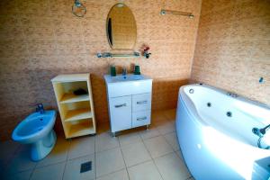 a bathroom with a tub and a sink and a toilet at Pensiunea Gerard 2 Mai Camere Moderne cu baie privata, la 250 M de plaja ,Foisor, Parcare & WIfi Gratuit in 2 Mai +25 photos