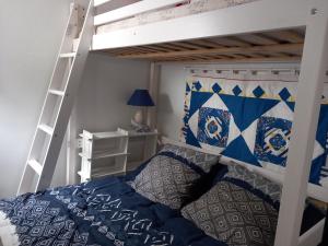 a bedroom with a bunk bed and a ladder at La Petite de Cayola in Talmont