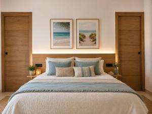a bedroom with a large bed with two pictures on the wall at Bungalows y Glamping Medina Sidonia in Medina Sidonia +128 photos