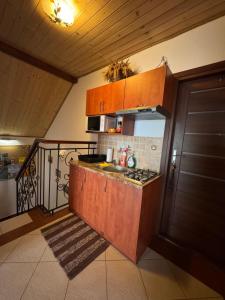 a small kitchen with a sink and a stove at Pokoje u Joli Polańczyk in Polańczyk