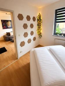 a bedroom with a white bed and a wall with hearts at Smartes Panorama City Apartment - Top Location! in Halle an der Saale