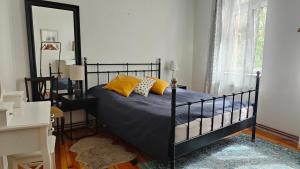 a bedroom with a black bed with yellow pillows at Prad 543 in Poznań