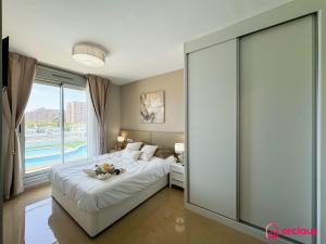 a bedroom with a bed and a large window at Sun & Sea in Cabanes