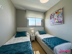 a bedroom with two beds and a window at Sun & Sea in Cabanes