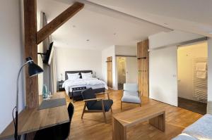 a bedroom with a bed and a living room at Backbord Geesthacht in Geesthacht