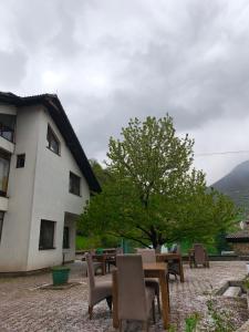 a table and chairs in front of a building at Hideout Guest House in Travnik