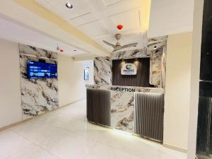 a reception area in a room with marble walls at Hotel Pacific Empire in Ahmedabad