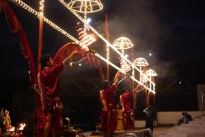 a group of men standing around a pole with lights at The Ushmaya Lifestyle Wellness Resort Near Rishikesh in Haridwār