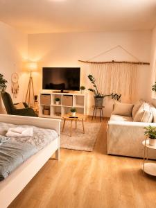 a living room with a bed and a couch at Penzion Lederer in Dolní Dunajovice +118 photos