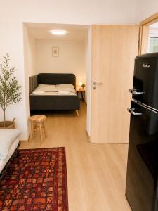 a living room with a bed and a couch at Penzion Lederer in Dolní Dunajovice