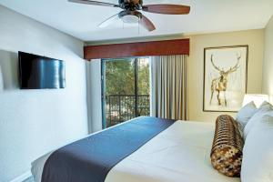 a bedroom with a bed with a ceiling fan and a window at Durango Resort 1BR Apartment in Durango