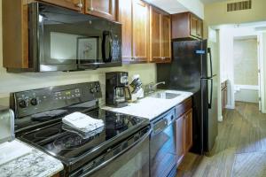a kitchen with a stove and a sink at Durango Resort 1BR Apartment in Durango +16 photos