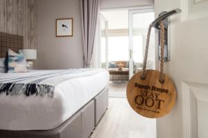 a bedroom with a bed with a sign that reads bench house stay out at Beach House Hotel in Seahouses