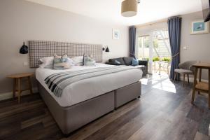 a bedroom with a large bed in a room at Beach House Hotel in Seahouses