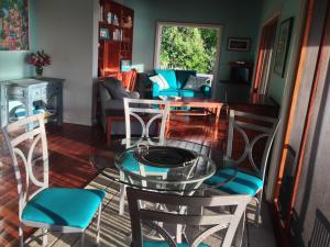 a dining room with a glass table and chairs at Blue Moon Antigua in English Harbour Town