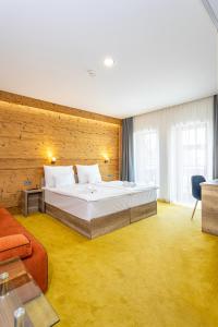 a hotel room with a bed and a couch at Hotel Kristály Konferencia & Wellness in Ajka +106 photos
